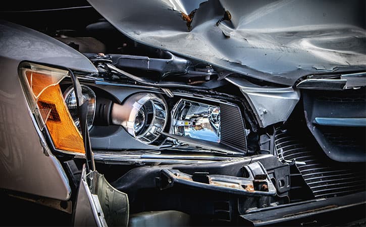 Crashed insurance claim car with damaged bonnet and front-end.