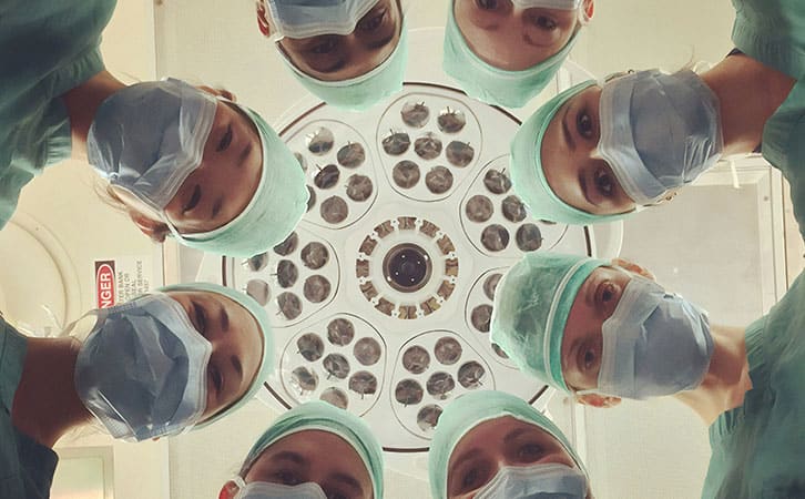 A group of medical practitioners wearing scrubs